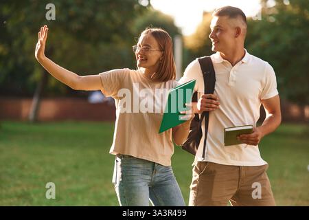 Two students are together outdoors. Stock Photo