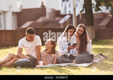 Preparation, sitting and learning. Group of students are outside together. Stock Photo