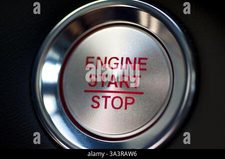 Modern Vehicle Start Stop Engine Button with Red Letters on Black Horizontal Stock Photo