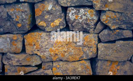 Close up of a dry stone wall background and texture Stock Photo