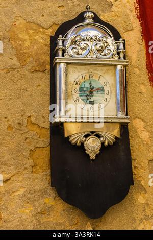 Vintage Wall Clock With Ornamental Silver Plating on Rustic Background Stock Photo