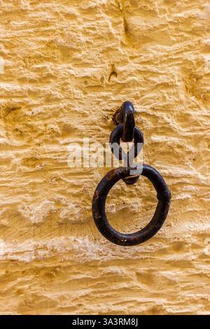 Close-Up of an Old Metal Door Ring on a Textured Wall Stock Photo