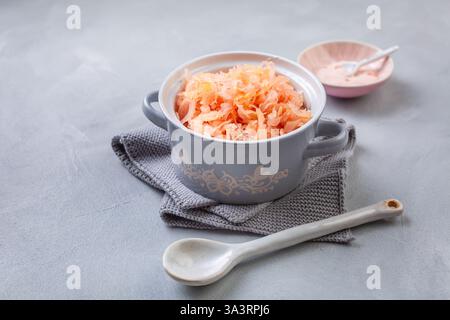 Fermented cabbage or sauerkraut in a  pot with salt Stock Photo
