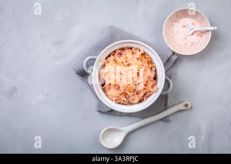 Fermented cabbage or sauerkraut in a  pot with salt Stock Photo