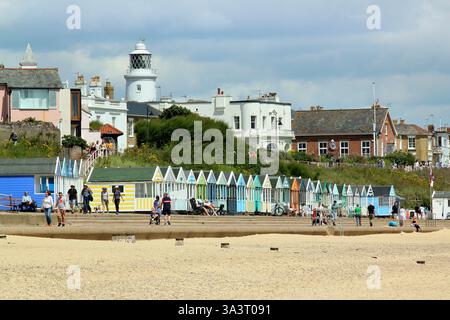 Southwold seafront.  Southwold lighthouse and beach huts seen from Southwold beach in summer, Suffolk, UK. Stock Photo