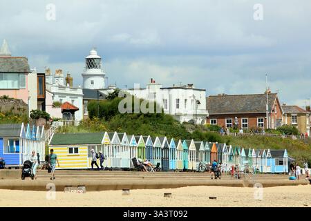 Southwold seafront.  Southwold lighthouse and beach huts seen from Southwold beach in summer, Suffolk, UK. Stock Photo