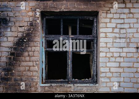 Window of burnt house. Consequences of fire. Stock Photo