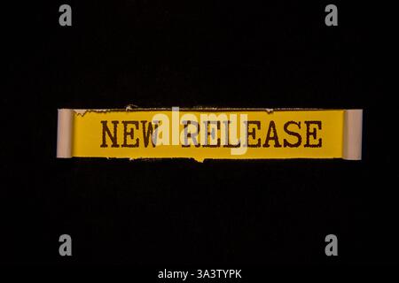 NEW RELEASE text on chalkboard on the wooden background. Stock Photo