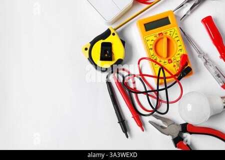 Different electrical tools on light background, flat lay. Space for text Stock Photo