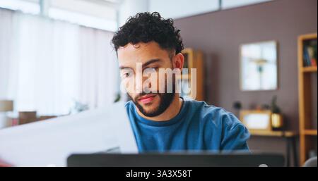 Businessman, laptop and checking with documents for finance, budget or bills at home. Man, freelancer or user with paperwork, invoices or payments for Stock Photo