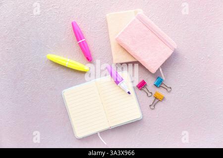 Composition with notebooks, markers and binder clips on light background Stock Photo