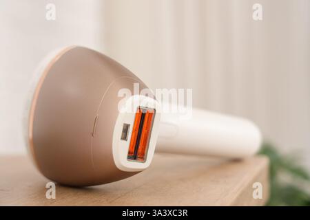 Modern photoepilator on table in bathroom, closeup Stock Photo