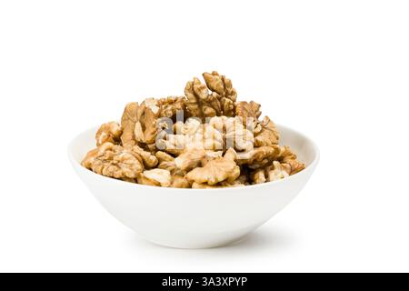 Shelled walnuts into bowl on white background. Stock Photo