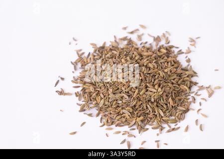 Dried raw organic fennel seeds. Closeup fennel seeds on bowl isolated on white by top view. Heap pile of dried fennel dill seeds. Copy space for text Stock Photo