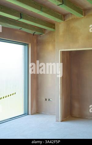 Newly plastered room. Building work finished with a smooth flat surface of thin plaster. A great skill. Stock Photo