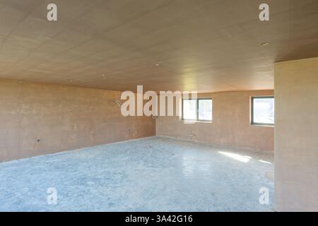 Newly plastered room. An unfinished kitchen. Building work finished with a smooth flat surface of thin plaster. A great skill. Stock Photo