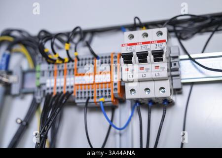 Close-up of circuit-breakers and cables in an electrical system, showing precision in the arrangement of components, switch cabinet construction, PV s Stock Photo