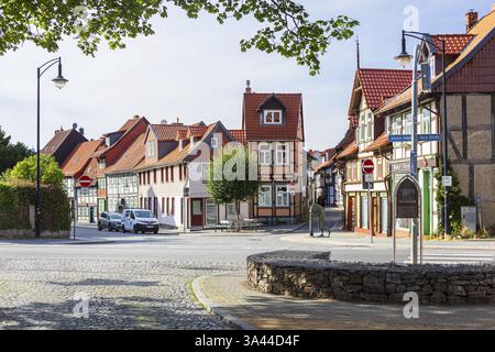 Remains of an old town tower, the Dullenturm, behind it old houses of the craftsmen's quarter and sculpture Die Rast, old town centre of Wernigerode, Stock Photo