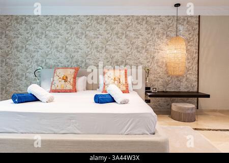 a close up image of a large bed with colourful towels in luxury holiday apartment Stock Photo