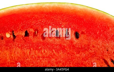 Cut ripe juicy red watermelon with seeds close-up on white background Stock Photo