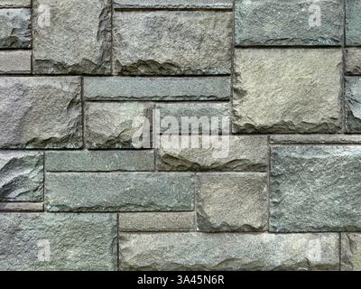 Unique natural stone tiles wall texture in mix of grey and light blue color with random abstract veins. Honed and rough outdoor grey flag stone tiles Stock Photo