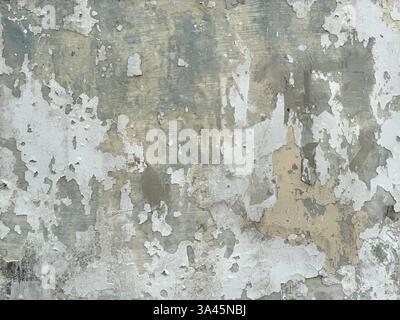 Close up of weathered and corroded wall surface. Old wall grunge and dirt texture decayed by weather and age. Seamless background texture. Stock Photo