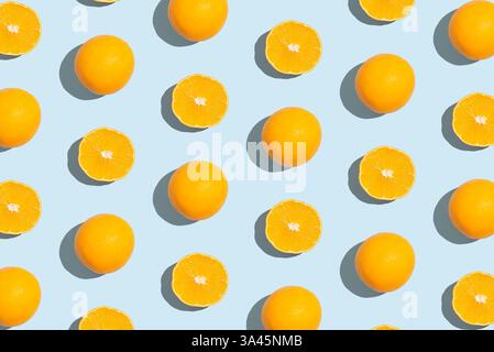 Pattern of an orange slices on pastel blue background. Creative fruit pattern, top view Stock Photo