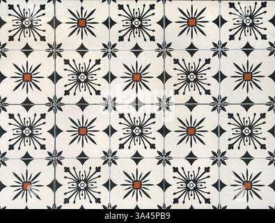 Colonial heritage patterned tiles in random geometric floral, star, and ornamental patterns. Handmade colonial tiles, or old heritage tiles in black, Stock Photo