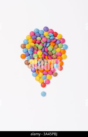 Brightly coloured sweets on white background. Rainbow colored candy. Happiness and cheerfulness concept, top view Stock Photo