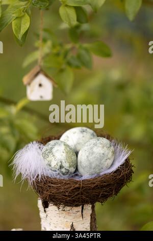 Easter eggs in a nest on the fence Stock Photo