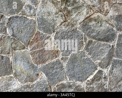 Natural random cut grey flagstone flattened on a surface. Or a series of cobble stones but flattened and paved seamlessly, for floor or wall finishes Stock Photo