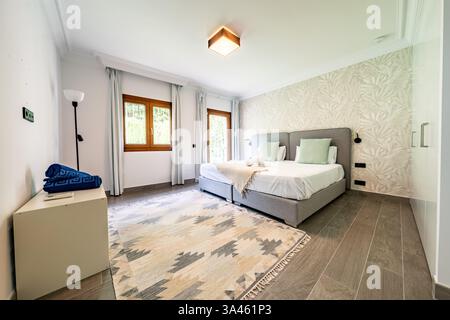 an image of two single beds together in mediterranean guest house Stock Photo