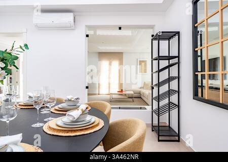 a close up image of tableware on a round dining table in luxurious mediterranean real estate Stock Photo