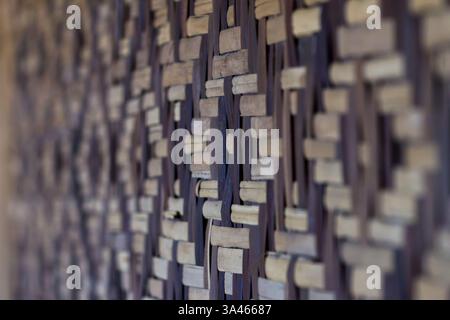 Asian Intricate Woven Bamboo Wall Texture. Close-up of a woven bamboo wall with intricate patterns. Stock Photo