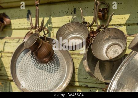 Vintage Copper Kitchenware Hanging on Rustic Wall in Bursa, Turkey. High quality photo Stock Photo