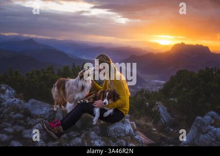 young woman with 2 Miniature Australian Shepherds Stock Photo