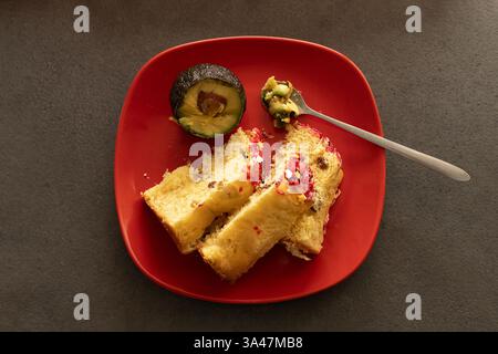 Two Easter cakes and avocado on a red plat Stock Photo
