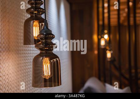 Close Up of Pendant Lights with Bronze Glass Shades in Luxury Interior Stock Photo