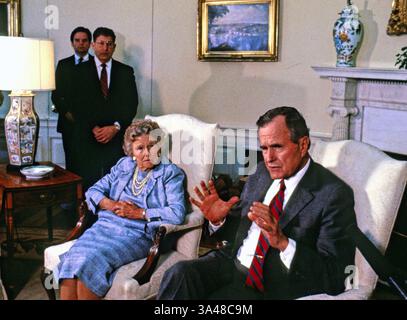 May 27, 2013 - Washington, District of Columbia, United States of America - United States President George H.W. Bush speaks to the press pool as his mother, Dorothy Walker Bush, 87, looks on in the Oval Office of the White House in Washington, D.C. during his first full day as President on January 21, 1989. White House Chief of Staff John Sununu stands in the back at left..Credit: Dennis Brack / Pool via CNP (Credit Image: © Dennis Brack/CNP/ZUMAPRESS.com) Stock Photo