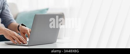 Unrecognizable man working on pc, typing text or programming code on computer keyboard Stock Photo