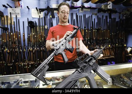 Aug. 7, 2014 - Dayton, OH, USA - Shawn Bertke, manager of Rich's Pawn Shop in Dayton, Ohio, has two guns for sale that look virtually alike. At left is a $45 Crosman BB gun; the other is a $1,200 real AR-15 rifle. (Credit Image: © Chris Stewart/MCT/ZUMA Wire) Stock Photo