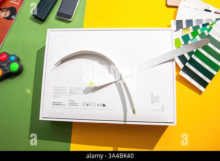 Paris, France - Mar 13, 2025: The MacBook Air M4 box is now opened with the white pull tab fully removed, displayed on a creative table setup with col Stock Photo