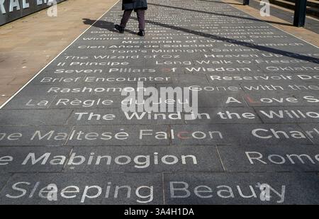 Titles of books written on ground in front of Central Library, Liverpool, Merseyside, England, UK red letters forma puzzle Stock Photo