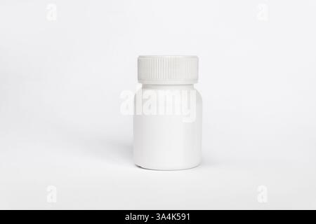 Close up of a plastic white jar with a lid for medicine isolated on a white background. Stock Photo