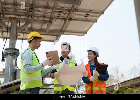 Sustainable technology. Engineers reviewing energy project plans with a focus on collaboration. Stock Photo