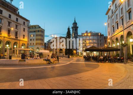 Varese, Italy at dusk. Square Monte Grappa, historic center with fountain and the bell tower Stock Photo