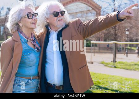 Happy caucasian senior couple exploring the city together on a sunny day outdoors. Stock Photo