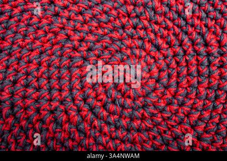 Knitted with a crochet hook, spiral shaped pattern texture, abstract  backdrop Stock Photo