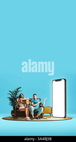 Happy couple sitting on couch, woman get her order in abstract living room, man pointing with smile to giant 3D model of smartphone with blank white Stock Photo