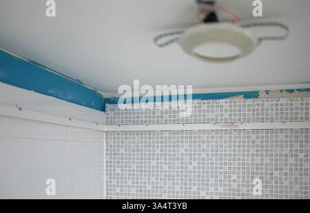 Replacing the stretch ceiling in the bathroom. Stock Photo